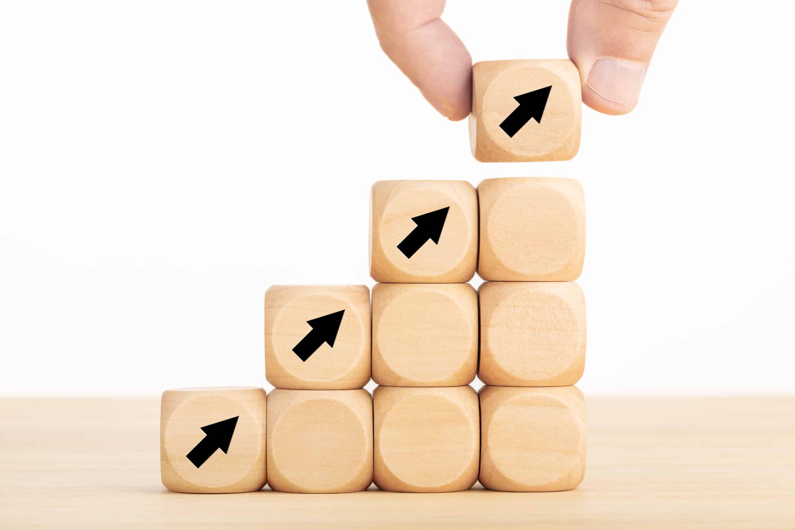 Business Growth Process Concept. Hand Holding A Wooden Block With Arrow Icon
